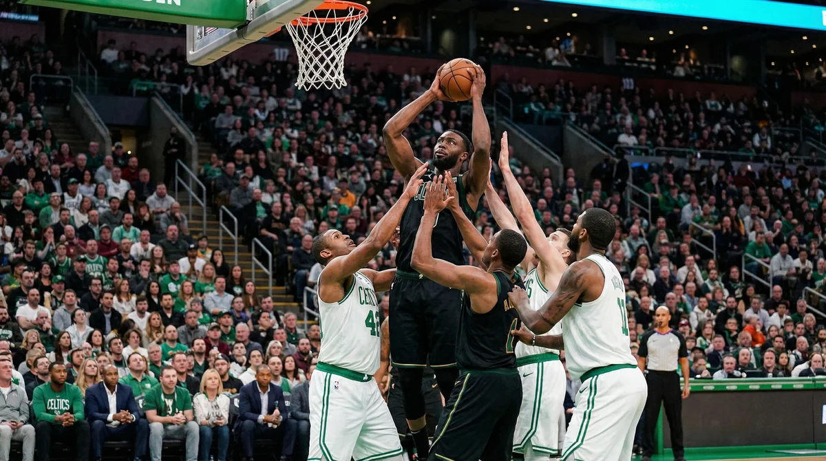 Игрова ситуация от мач в НБА в зала TD Garden, при която център взима борба под коша пред публика.