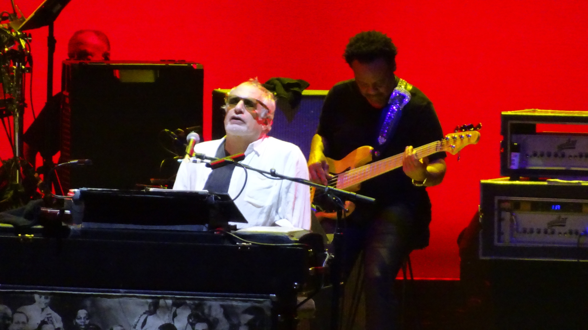Donald Fagen performs on a keyboard in a concert
