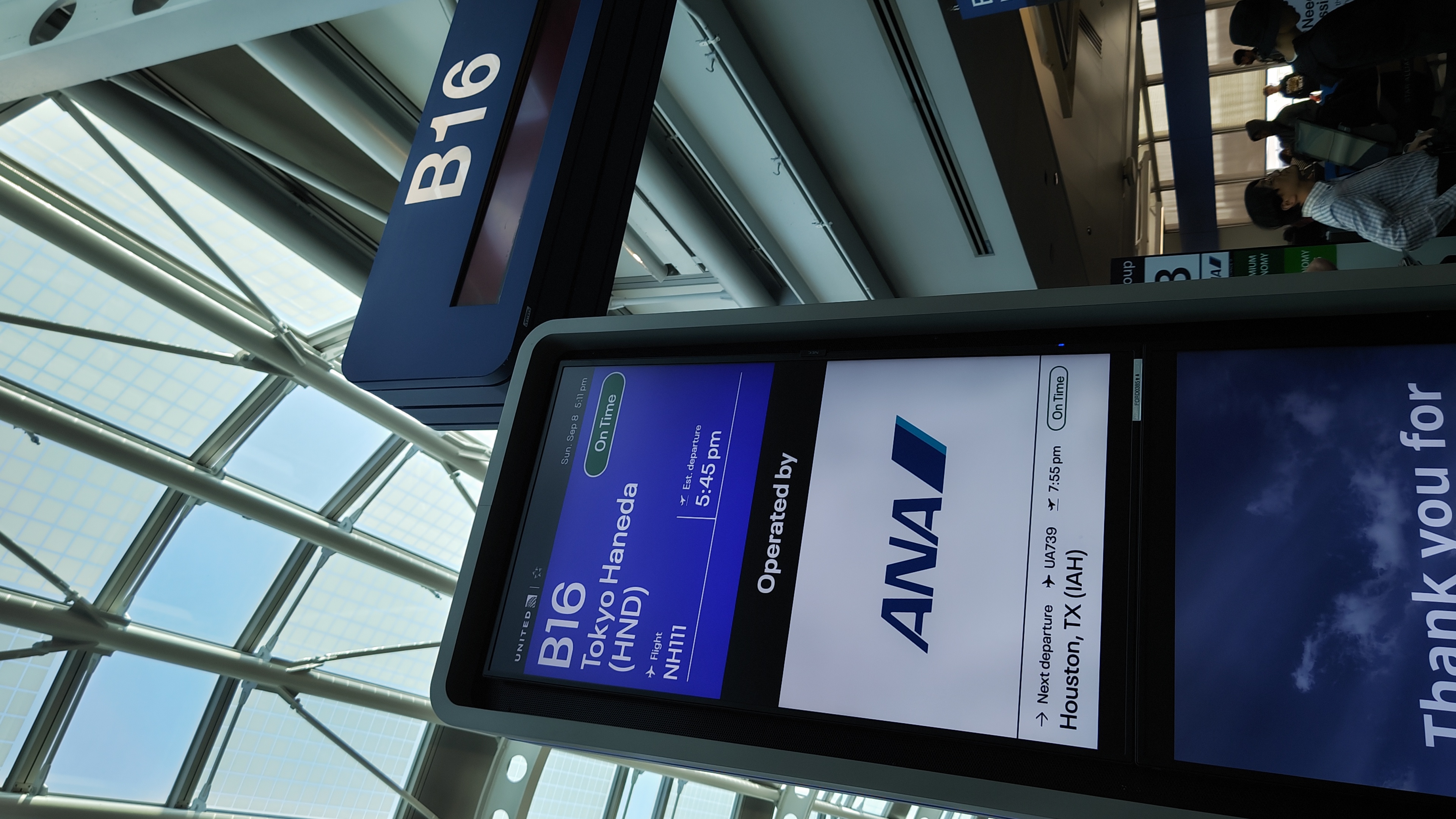 A photo of a gate information display at Chicago O'Hare Airport. On the right is the sign for gate B16. The plane is an ANA Flight to Tokyo Haneda.