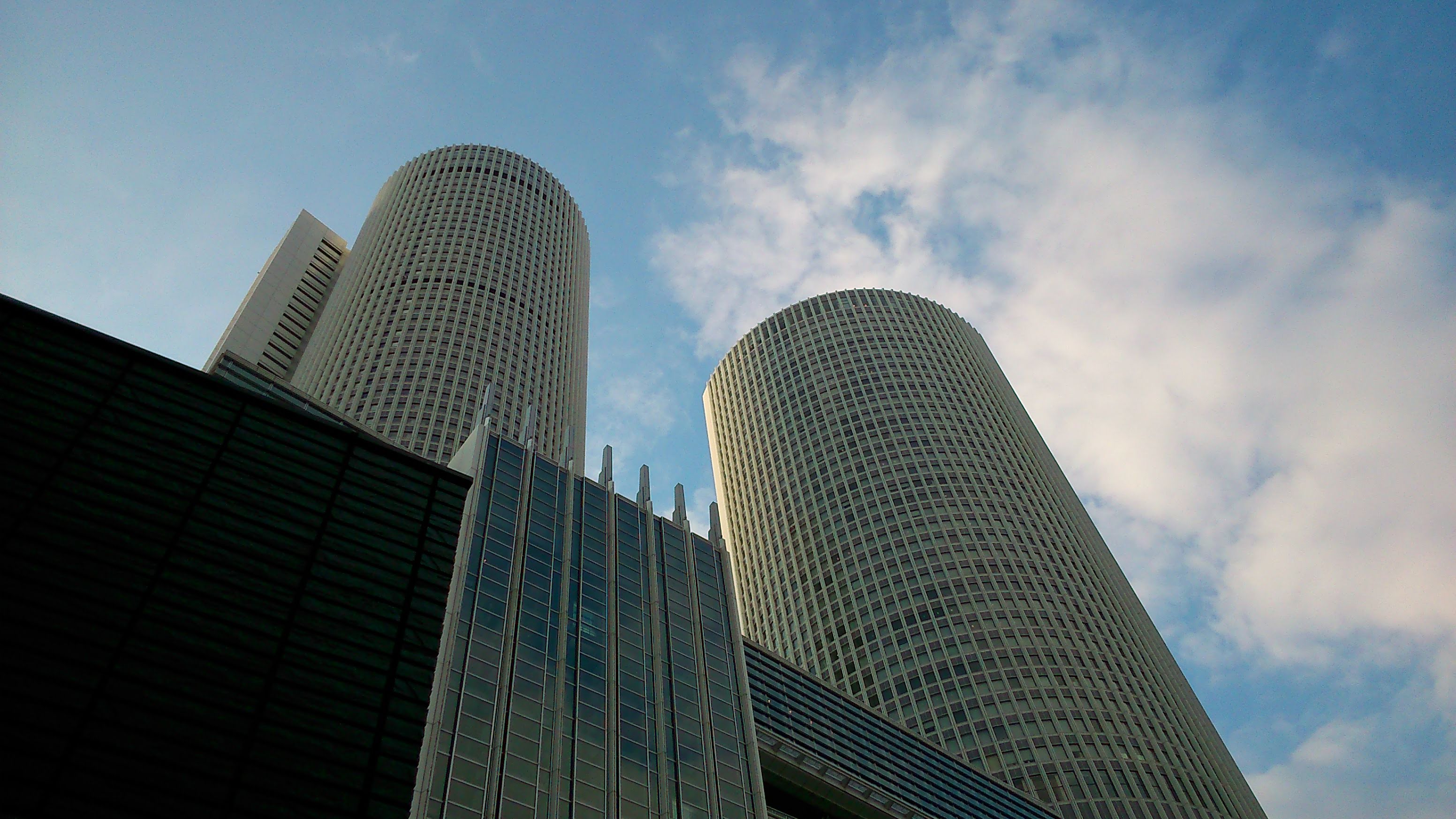 The Nagoya Marriott Associa hotel towers shot from the street plaza below them. They are part of the JR station.
