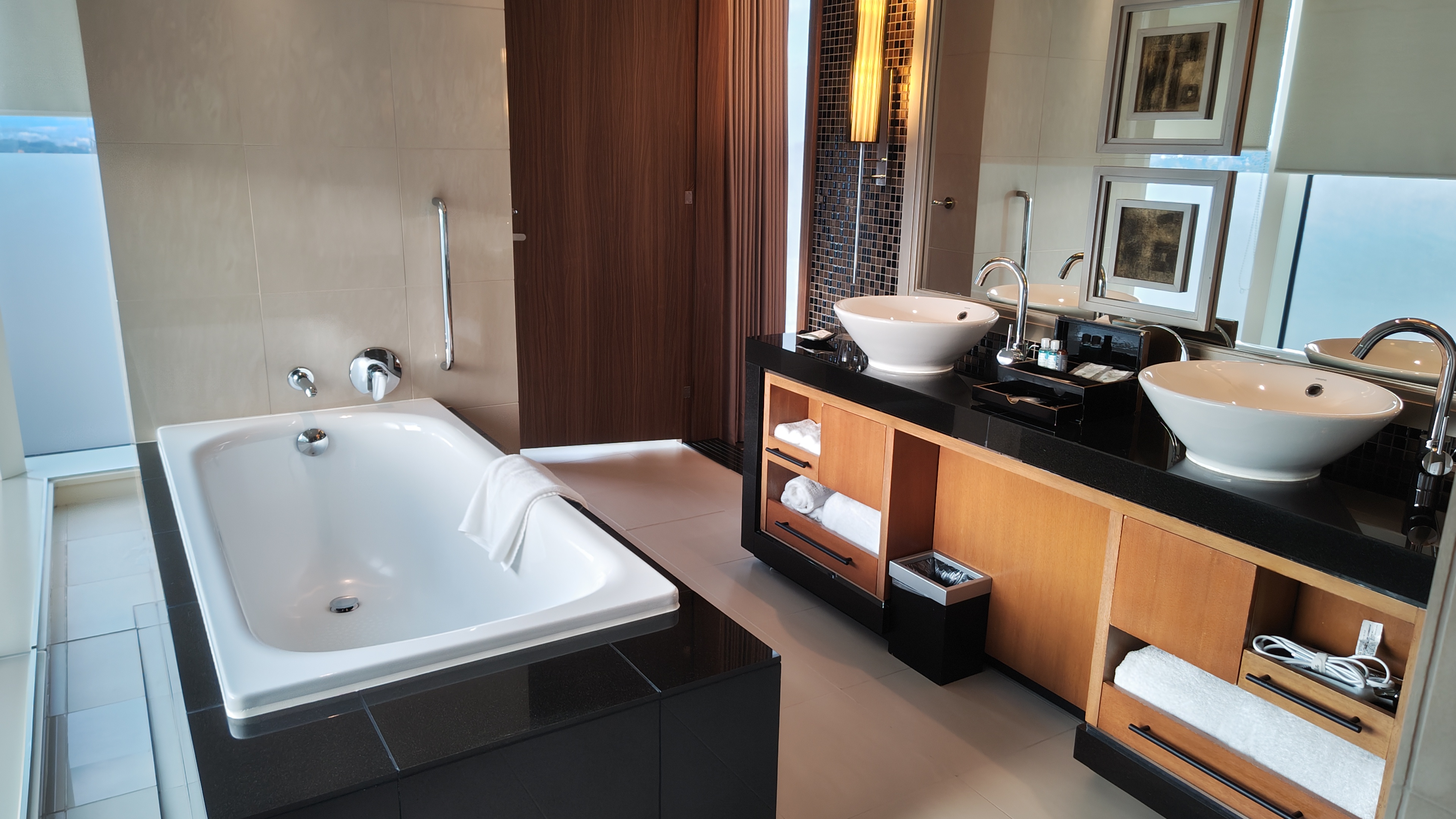 A bathroom with part of a bathtub visible and a bathroom vanity