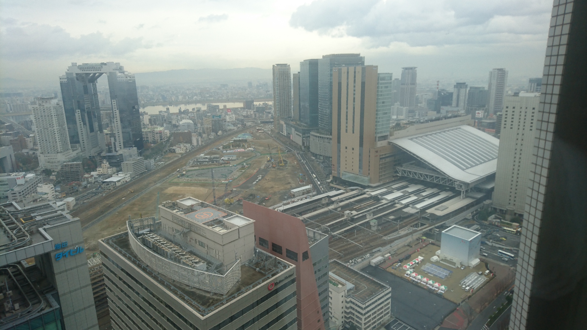 An aerial shot of Osaka station with its tracks with trains on them. It is shot from a hotel room at the Osaka Ritz Carlton.