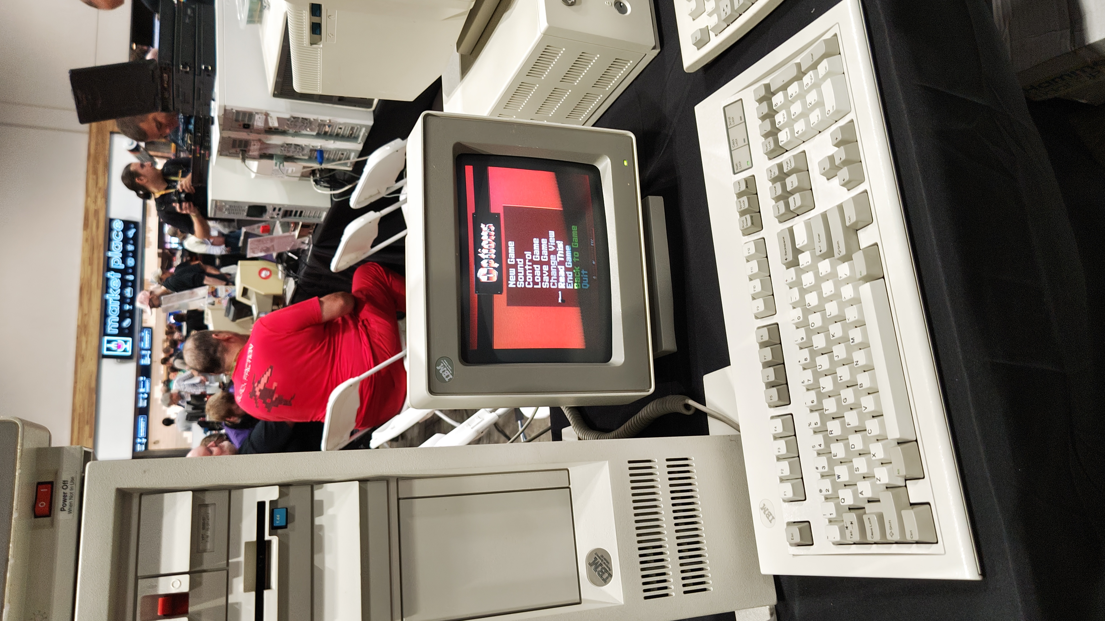 A IBM PS series workstation next to an IBM monitor with the Options screen of Wolfenstein 3D present